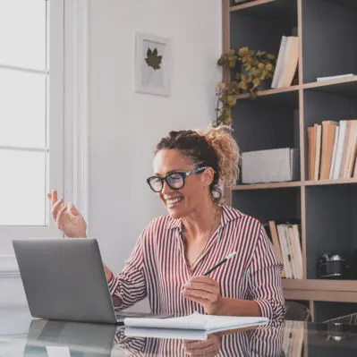 One young woman working at home in the office with laptop and no