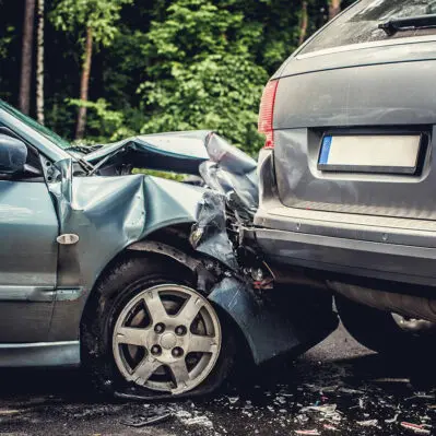 Close up smached cars on a road.